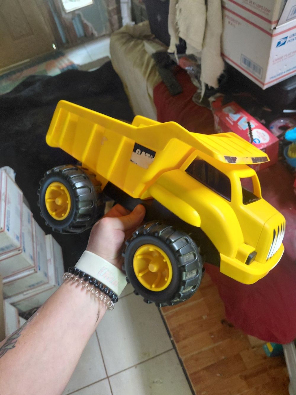 yellow CAT (Caterpillar) Construction Dump Truck toy made from durable plastic.